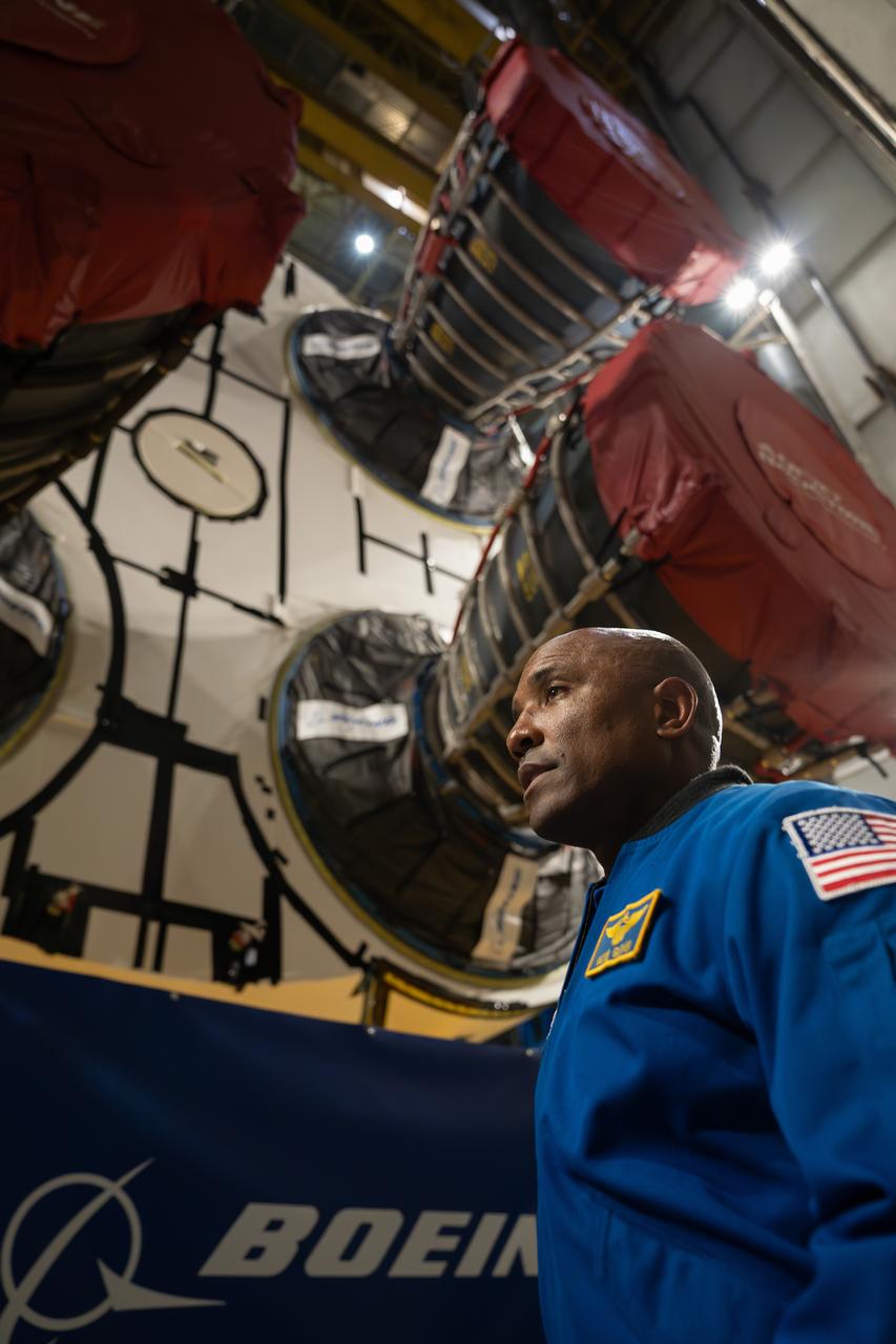 NASA astronaut Victor Glover views the core stage of the SLS (Space Launch System) rocket that will help power Artemis II at NASA’s Michoud Assembly Facility in New Orleans July 15. Glover will pilot Artemis II, the first crewed mission of NASA’s Artemis campaign. Crews moved the 212-foot-tall core stage with its four RS-25 engines to Building 110 at NASA Michoud prior to rolling it out to NASA’s Pegasus barge July 16 for delivery to NASA’s Kennedy Space Center in Florida.